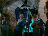 Kids brewing a magic potion under the watchful eye of a witch for Halloween, as part of the Potion Making Experience at Oxford Castle Prison