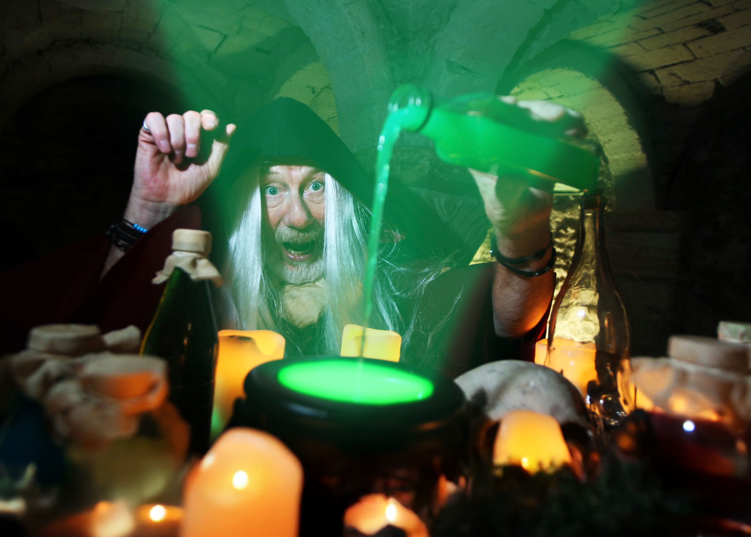 Merlin's apprentice brewing a magic potion for the Potion Making Experience (Halloween) at Oxford Castle Prison