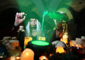 Merlin's apprentice brewing a magic potion for the Potion Making Experience (Halloween) at Oxford Castle Prison