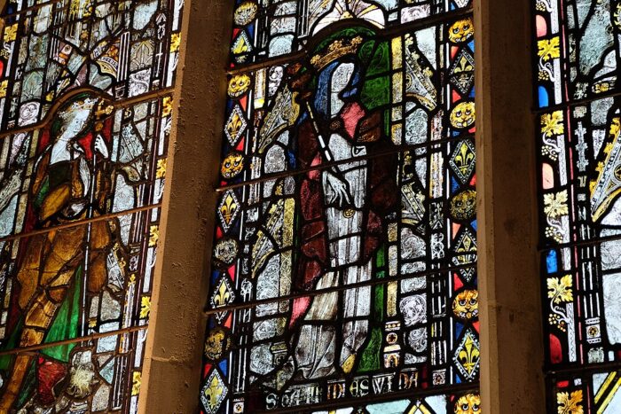 Section from 14th-century stained-glass window in the Latin Chapel of Christ Church Cathedral, Oxford, depicting St. Margaret with dragon, cross and palm; St. Frideswide with book and sceptre